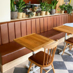 brown seats with tables and chairs